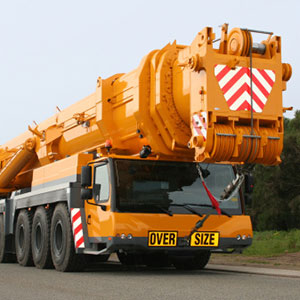 Mobile crane with boom on transport vehicle